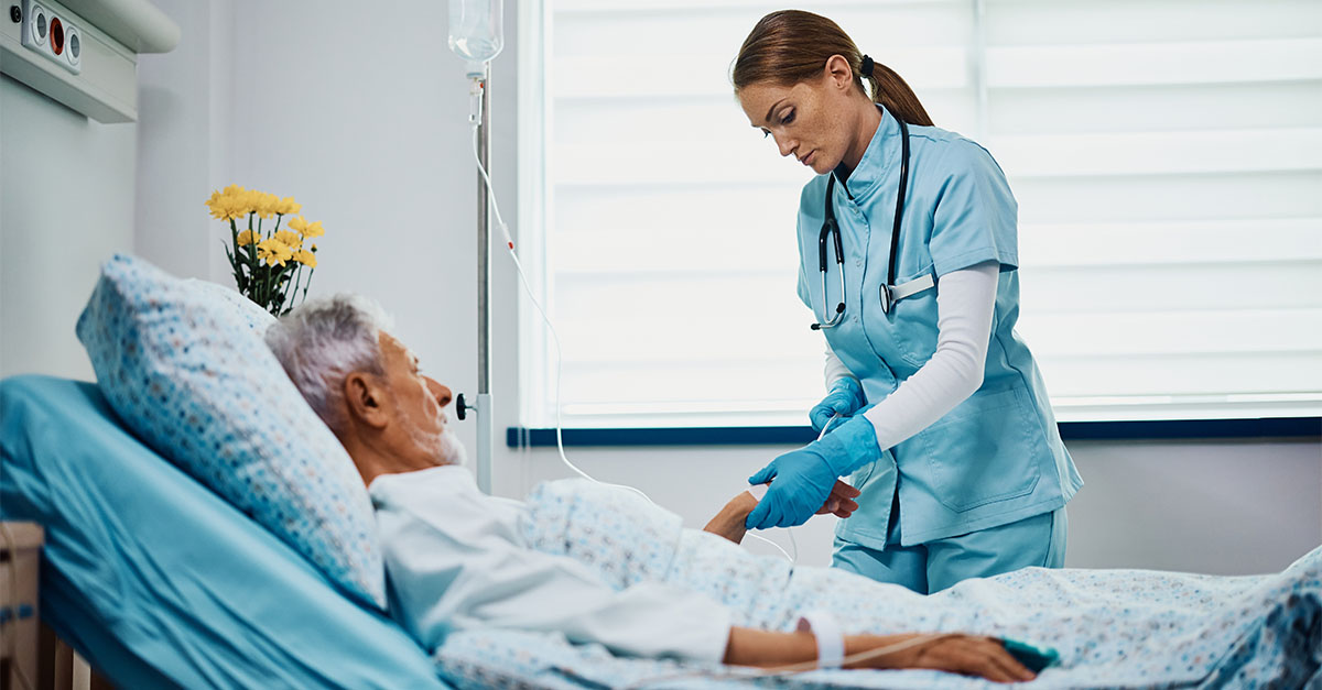 Nurse providing care to elderly hospital inpatient, representing changes in Medicare Inpatient PPS reimbursement