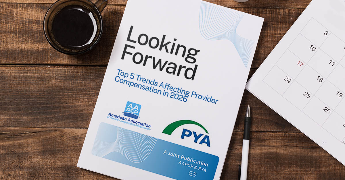 Cover of a publication titled “Top 5 Trends Affecting Provider Compensation in 2026” displayed on a desk next to a calendar, pen, and coffee cup