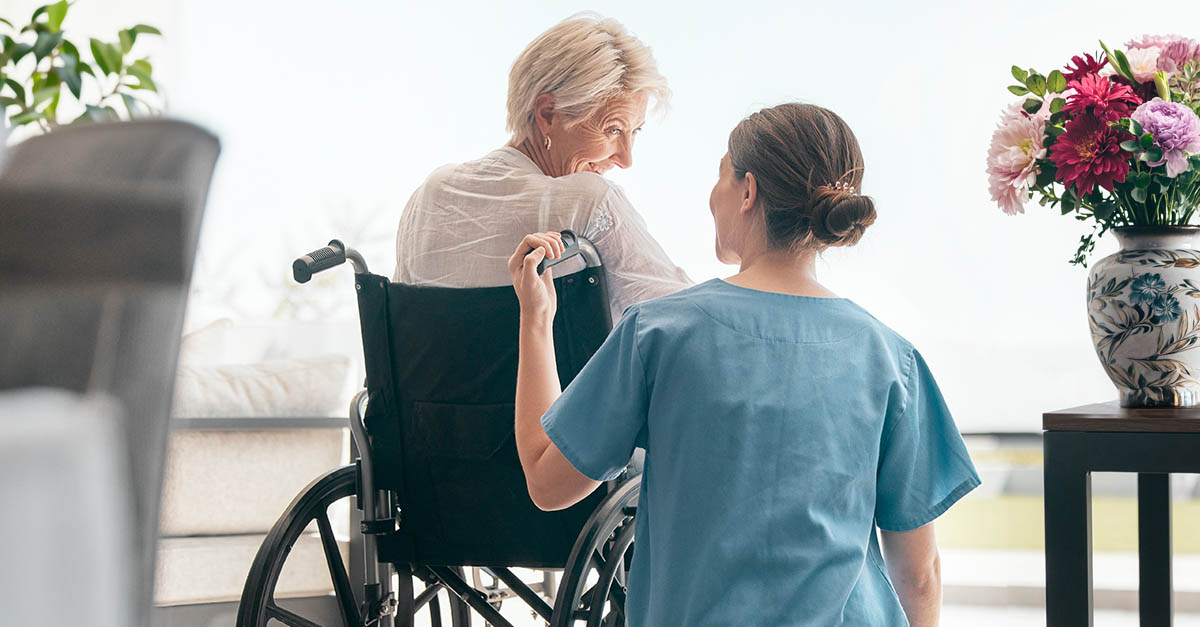 Elderly woman with nurse in a long-term care facility with spring flowers, representing CMS FY 2027 proposed payment and policy updates