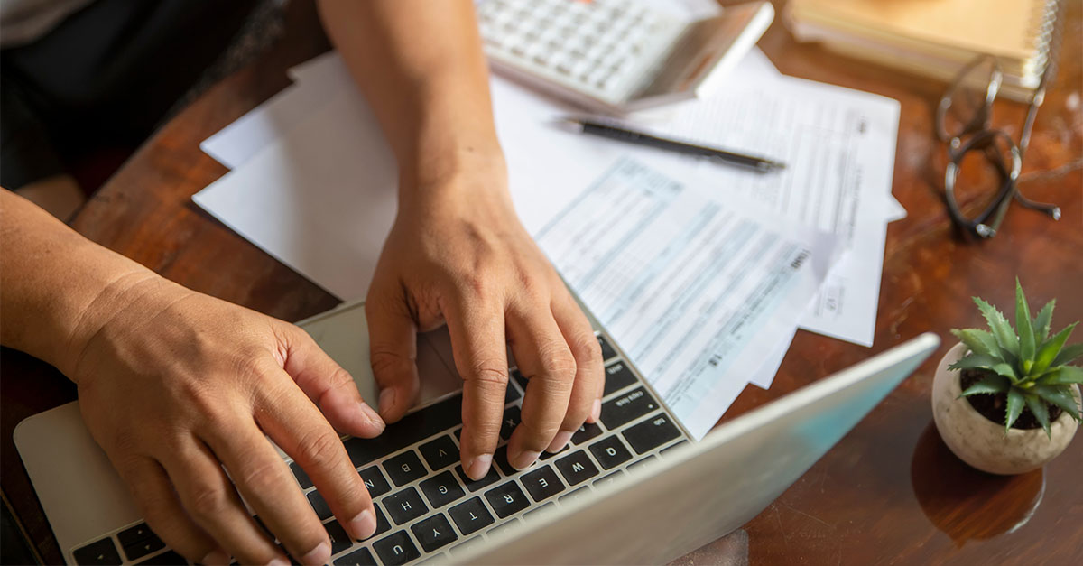 Individual using a laptop to access tax documents and manage an IRS Individual Online Account for secure tax records, payments, notices, and taxpayer services.