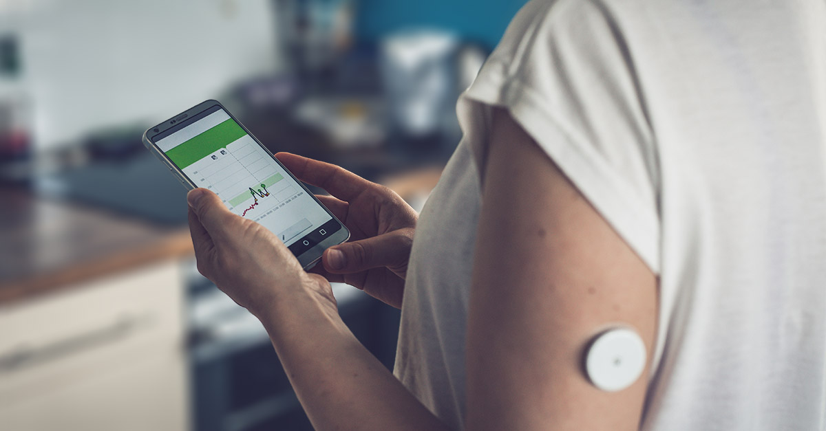 Patient using a smartphone with a wearable health monitor, representing the CMS ACCESS payment model, remote monitoring, and technology-supported chronic care
