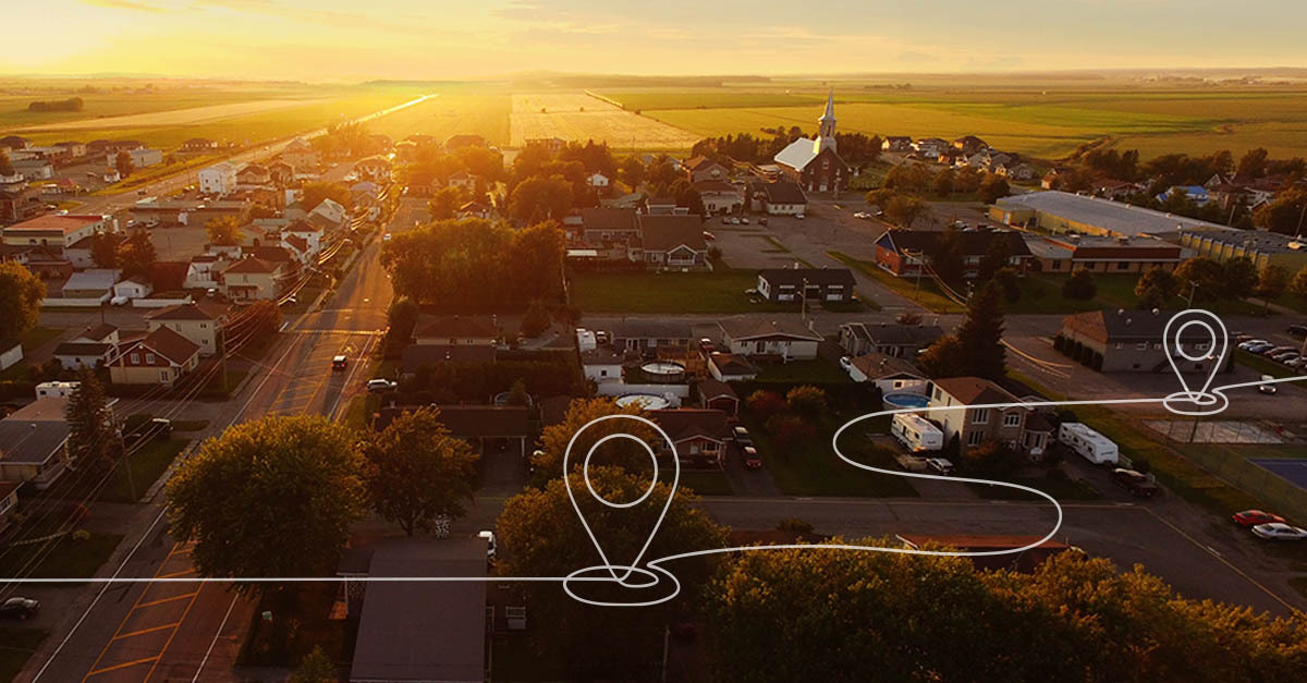 Aerial view of a rural community with location markers representing rural healthcare access and RHTP implementation