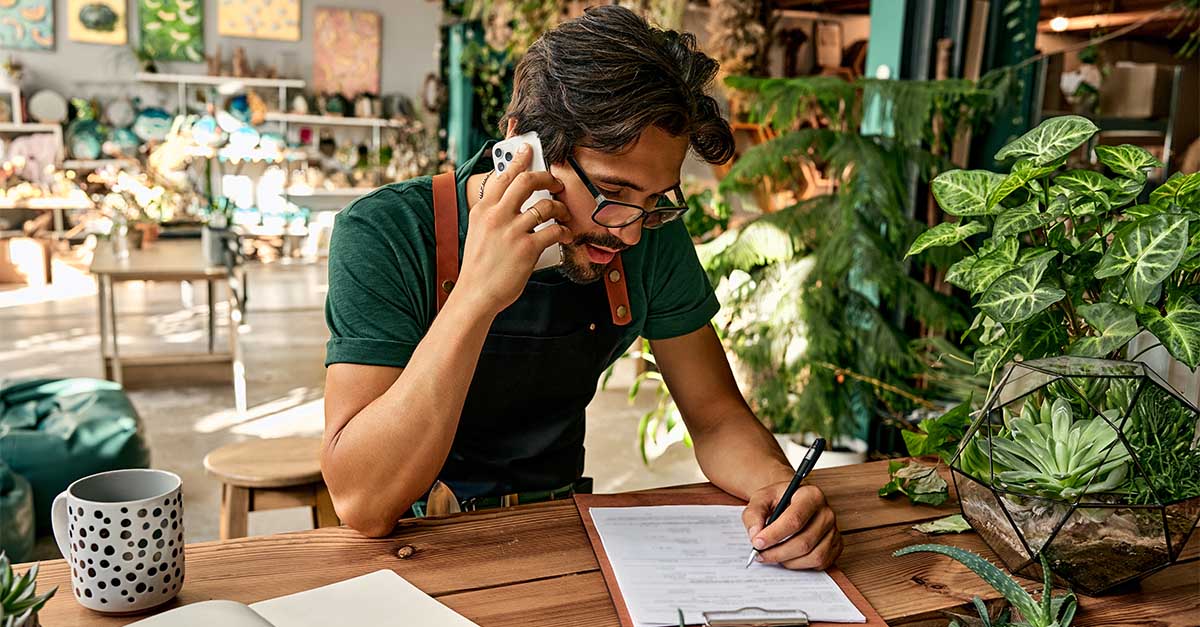 Business owner reviewing paperwork and records for 2026 Form 1099 reporting requirements