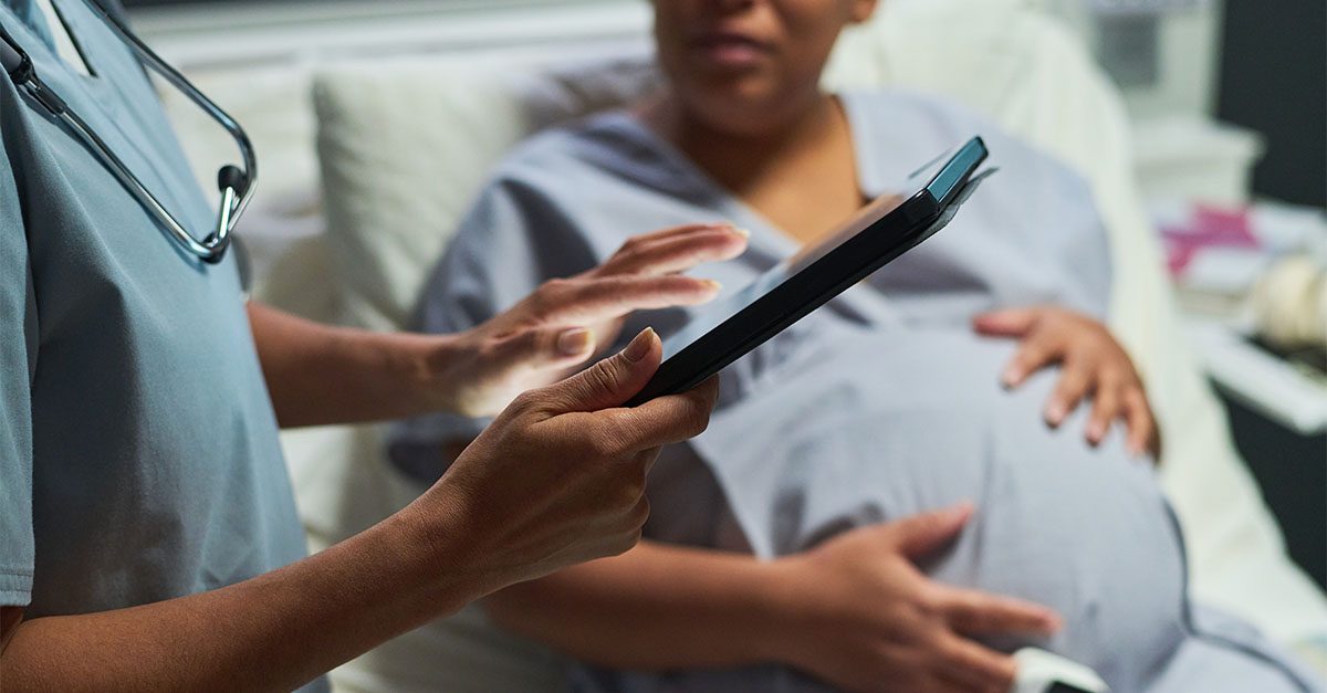 Healthcare professional reviewing maternity care information with a pregnant patient