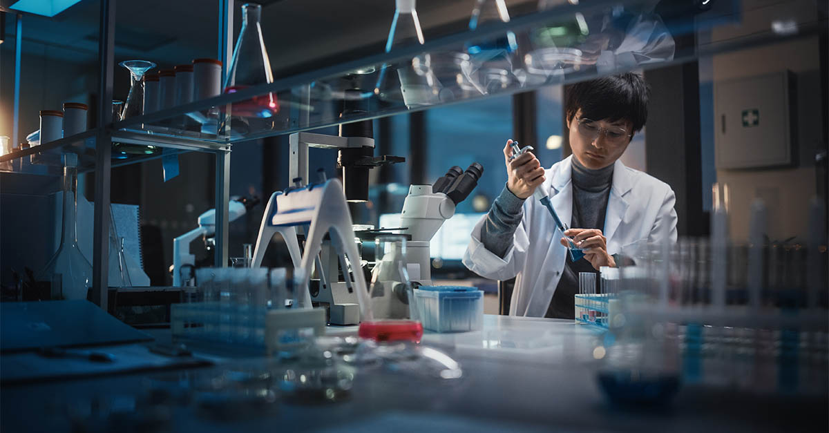 Clinical researcher using a pipette in a laboratory, representing PYA's Clinical Research Administration Office and clinical trial management services.
